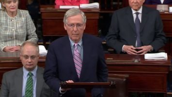 McConnell at a podium with senators behind him