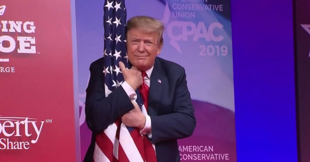 Trump hugging the American flag