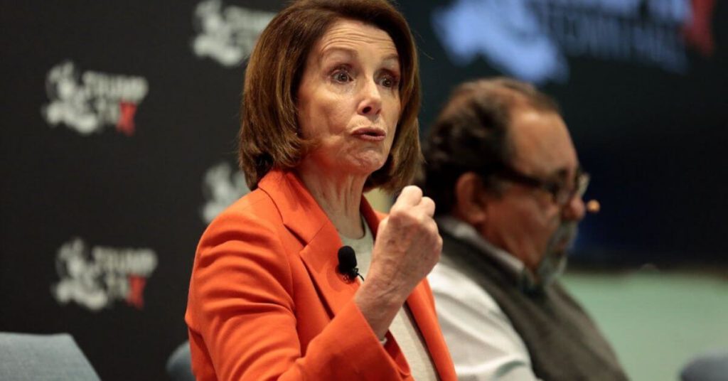 Nancy Pelosi holding up her fist