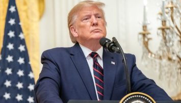 President Trump standing behind a podium