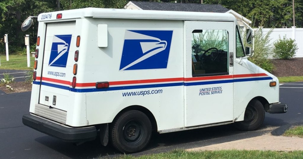 A postal truck driving down a road