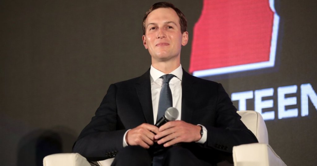 Jared Kushner sitting in a chair and grinning