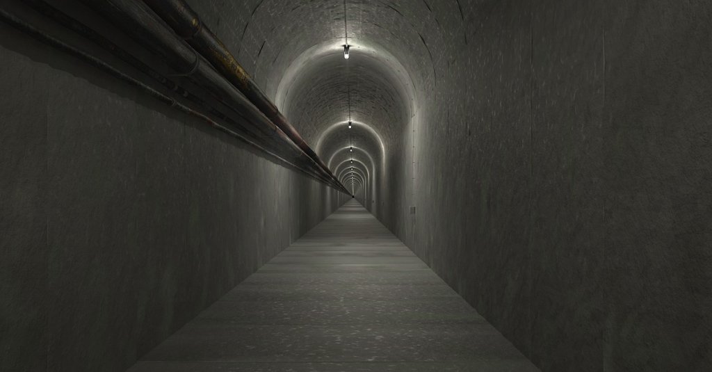 A photograph of a long concrete tunnel.