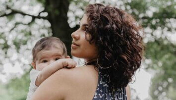 Mother holding her baby outdoors