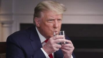 Trump trying to drink a glass of water