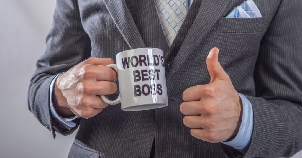 Man holding a "World's best boss" mug