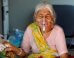 Lilaben Gautambhai Modi, 80, wearing an oxygen mask, sits inside an ambulance as she waits to enter a COVID-19 hospital for treatment